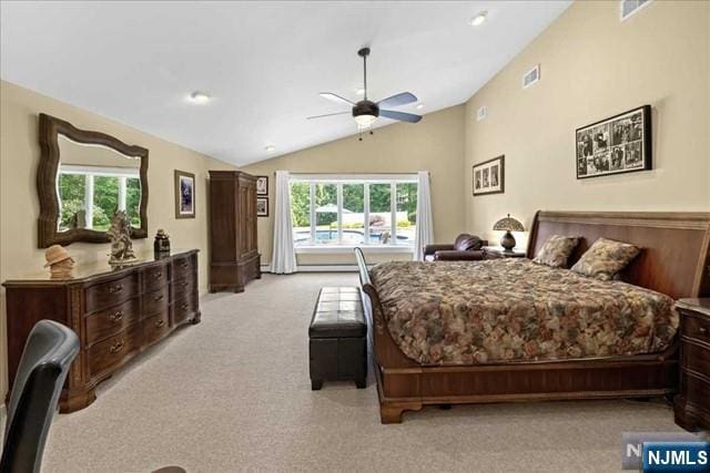 bedroom with multiple windows, visible vents, vaulted ceiling, and light colored carpet