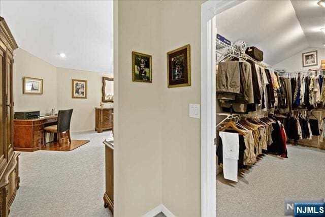 spacious closet featuring lofted ceiling and carpet