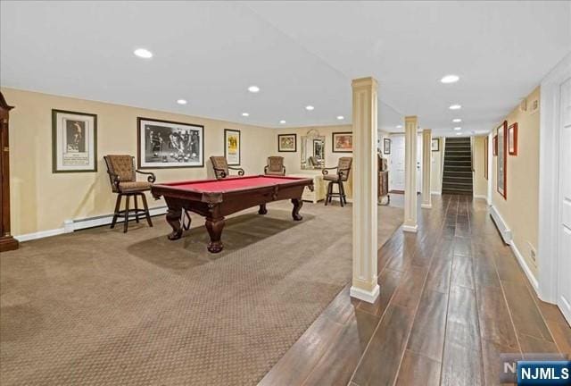 recreation room with decorative columns, baseboards, a baseboard radiator, dark wood-style flooring, and recessed lighting