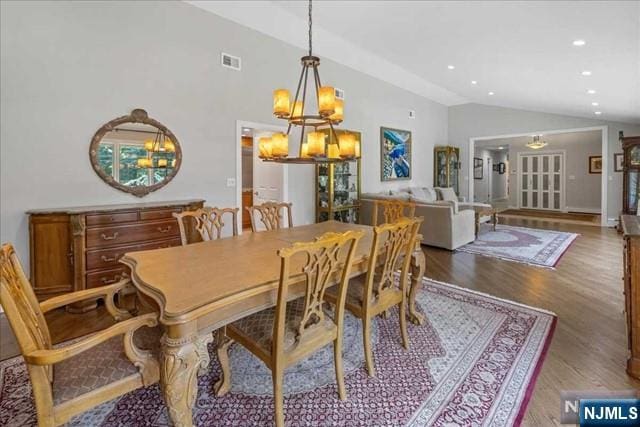 dining room with vaulted ceiling, wood finished floors, visible vents, and recessed lighting