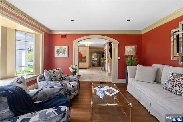 85 Buckhaven Hl, Upper Saddle River, NJ 07458 - living room featuring decorative columns, arched walkways, wood finished floors, crown molding, and baseboards