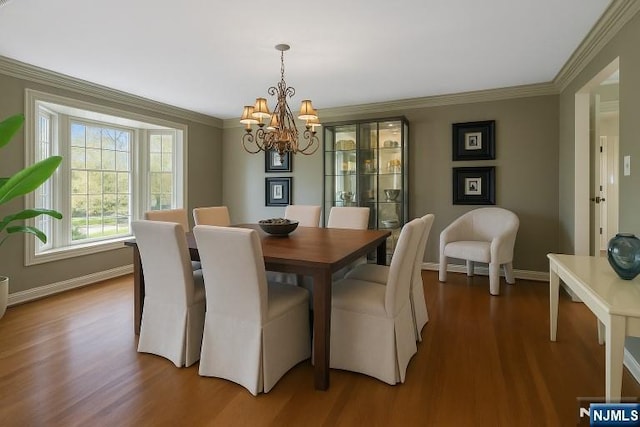 85 Buckhaven Hl, Upper Saddle River, NJ 07458 - dining area featuring a chandelier, crown molding, wood finished floors, and baseboards