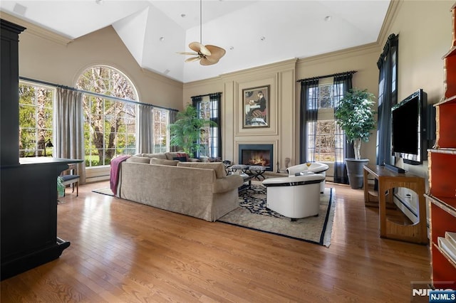 85 Buckhaven Hl, Upper Saddle River, NJ 07458 - living area with a ceiling fan, a lit fireplace, high vaulted ceiling, light wood-style floors, and ornamental molding