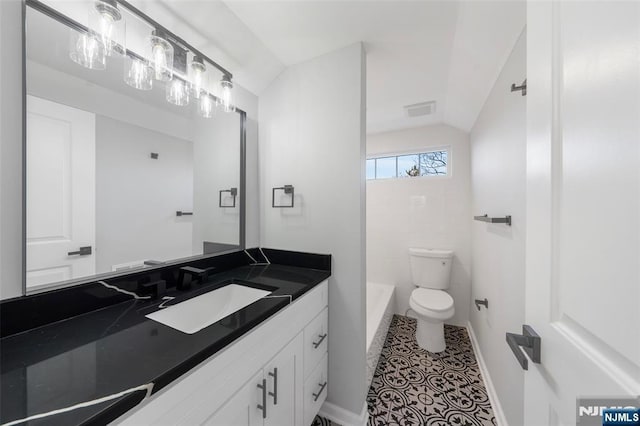 full bathroom featuring lofted ceiling, visible vents, toilet, and a bath