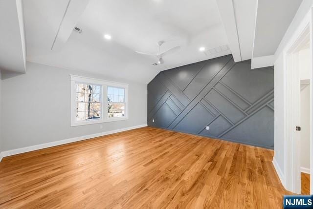 bonus room featuring baseboards, vaulted ceiling, visible vents, and light wood-style floors