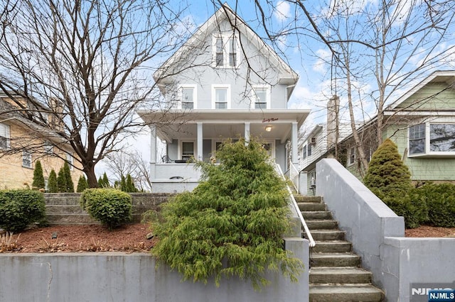 view of front of home featuring stairs and stucco siding