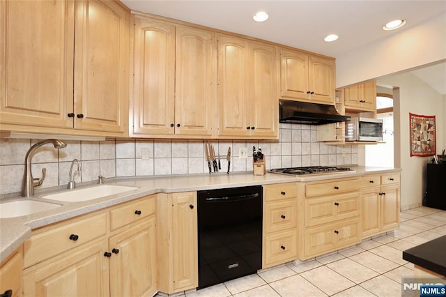 kitchen featuring light tile patterned floors, stainless steel appliances, light brown cabinetry, under cabinet range hood, and a sink