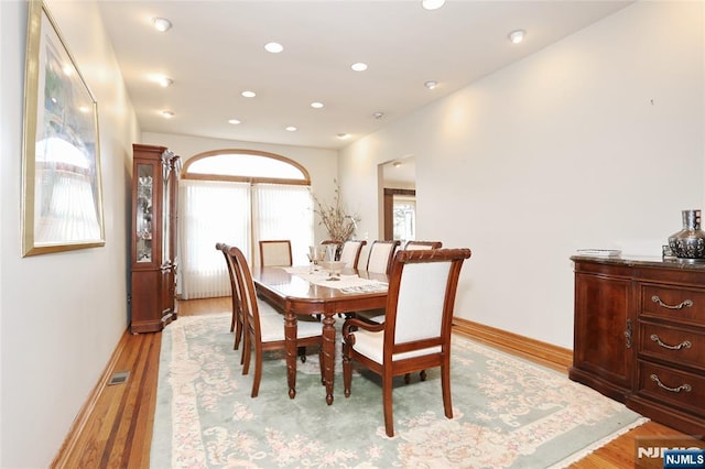 dining space with baseboards, light wood-type flooring, visible vents, and recessed lighting