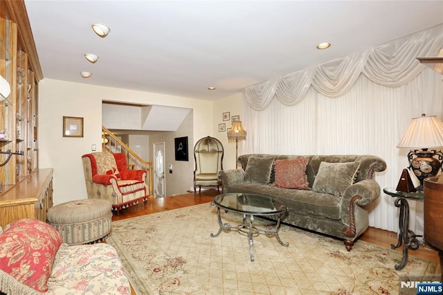 living room featuring stairs, wood finished floors, and recessed lighting