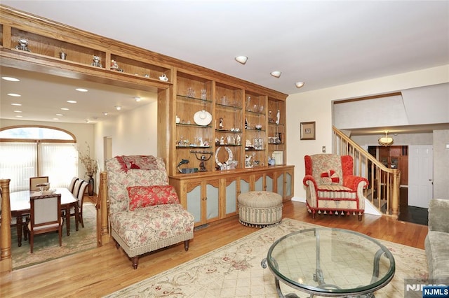 living area with stairway, wood finished floors, and recessed lighting