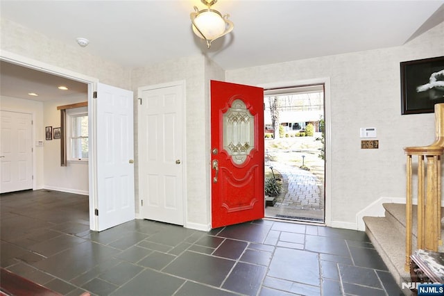 entrance foyer featuring a healthy amount of sunlight and baseboards