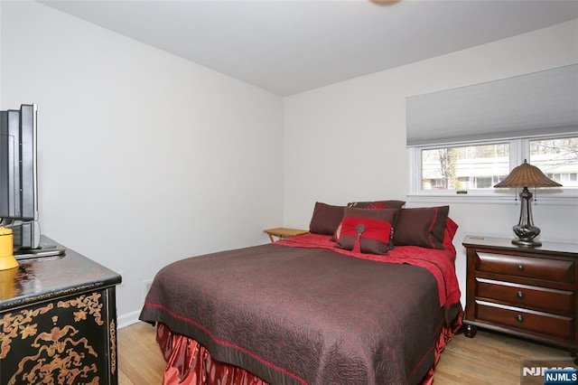 bedroom with wood finished floors