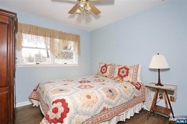 bedroom featuring a ceiling fan, baseboards, and dark wood-type flooring