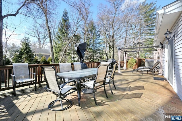 wooden deck with outdoor dining area