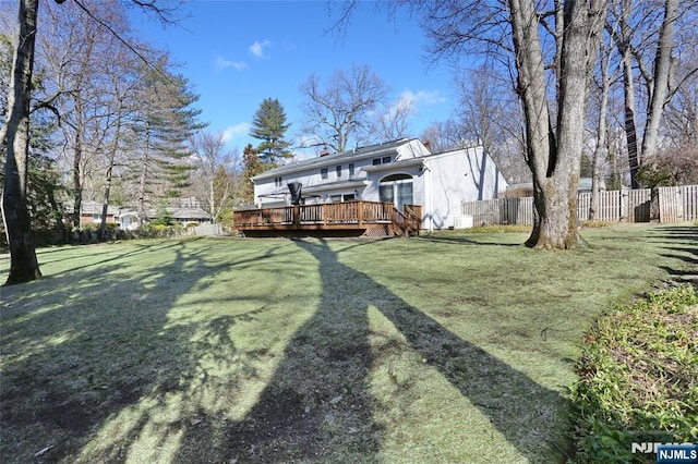 view of yard featuring fence and a wooden deck