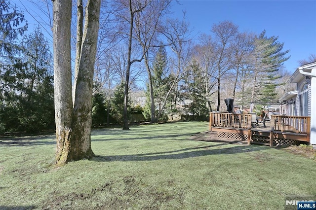 view of yard featuring a wooden deck