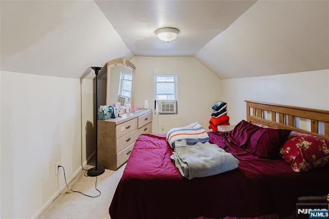 bedroom with baseboards, vaulted ceiling, cooling unit, and light colored carpet