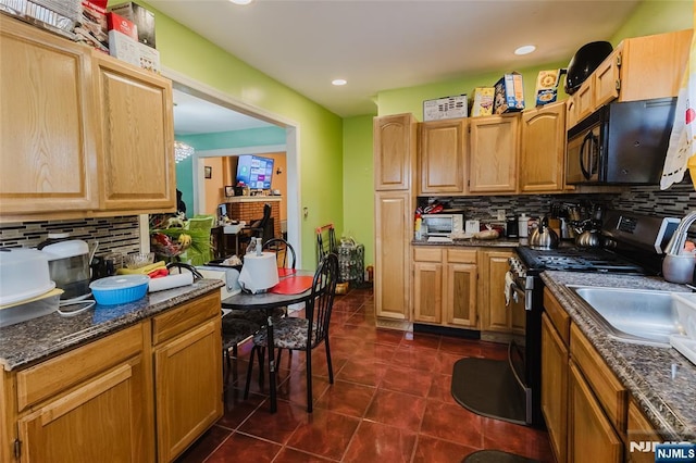 kitchen featuring recessed lighting, backsplash, gas stove, black microwave, and dark tile patterned floors