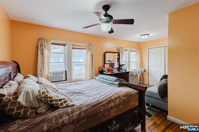 bedroom with ceiling fan, cooling unit, wood finished floors, baseboards, and access to outside