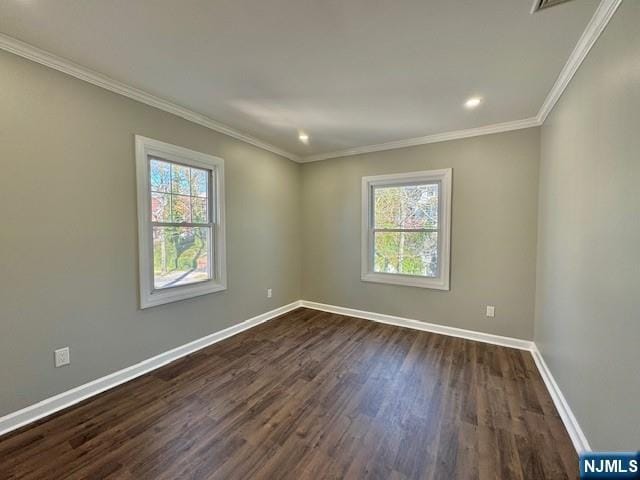 spare room featuring crown molding, recessed lighting, dark wood finished floors, and baseboards
