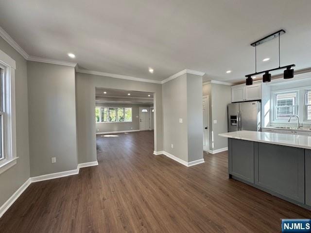 kitchen featuring light countertops, open floor plan, recessed lighting, dark wood finished floors, and stainless steel fridge