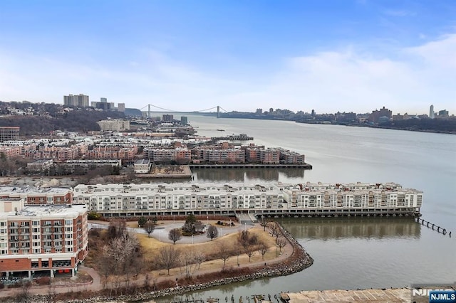 birds eye view of property featuring a view of city and a water view