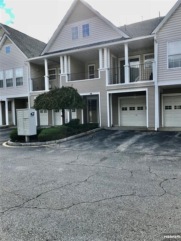 view of property featuring driveway and an attached garage