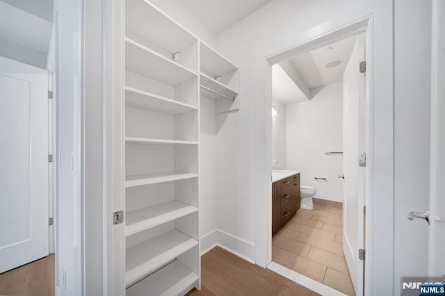 spacious closet featuring wood finished floors