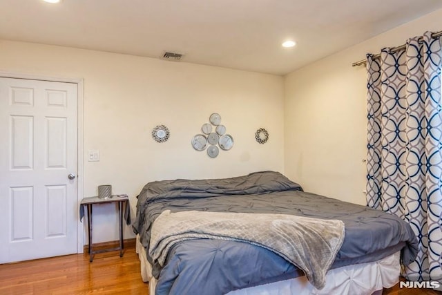 bedroom featuring recessed lighting, visible vents, and wood finished floors