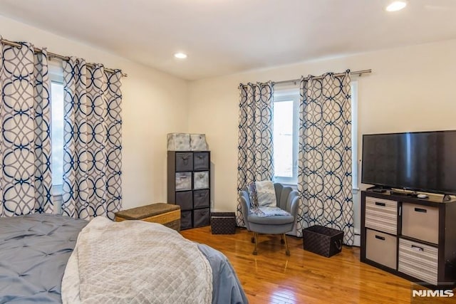 bedroom with recessed lighting and wood finished floors