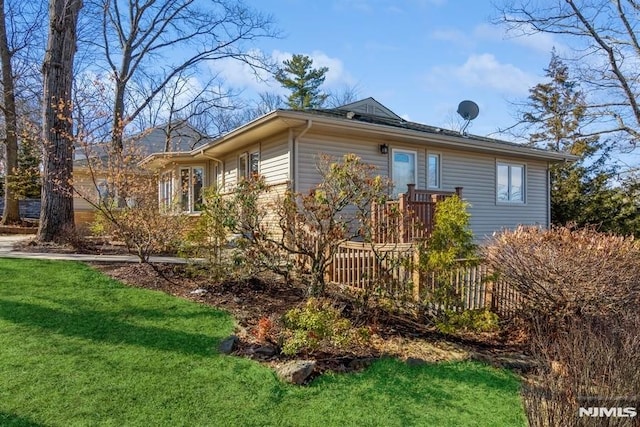 view of property exterior featuring a lawn