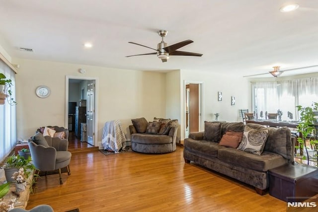 living area with light wood-style flooring, visible vents, a ceiling fan, and recessed lighting