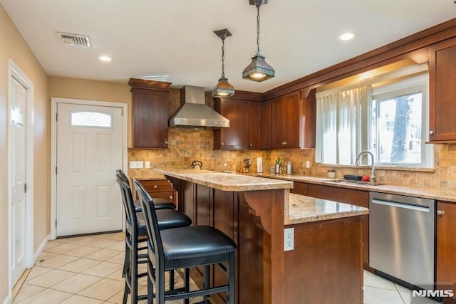 kitchen featuring light tile patterned floors, visible vents, wall chimney exhaust hood, stainless steel dishwasher, and a sink