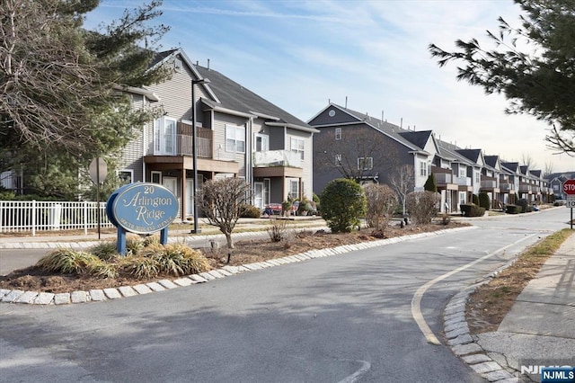 view of street with traffic signs, a residential view, and sidewalks