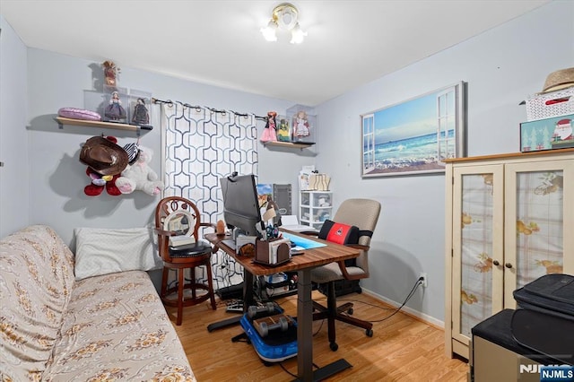 office space featuring baseboards, wood finished floors, and french doors