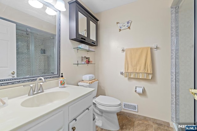 bathroom featuring baseboards, visible vents, a shower, toilet, and vanity