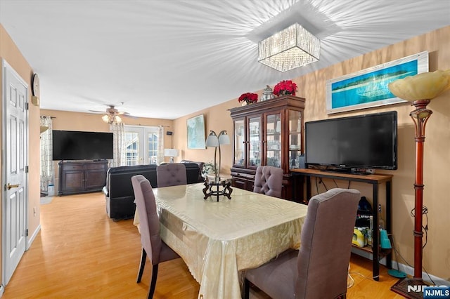 dining room with light wood-type flooring and a ceiling fan