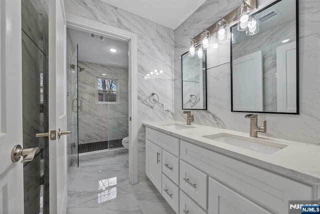 full bathroom featuring toilet, marble finish floor, visible vents, and a sink