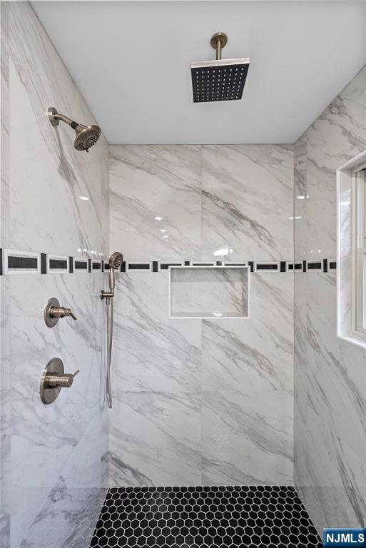 bathroom with a marble finish shower