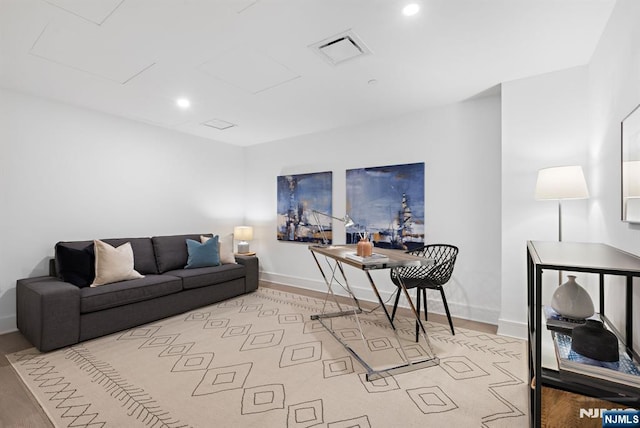 living room with baseboards, visible vents, attic access, and recessed lighting