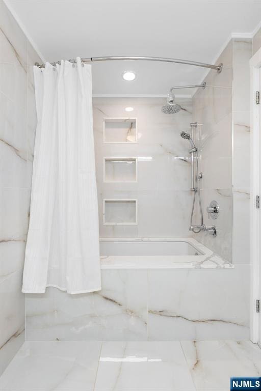 full bath featuring marble finish floor and shower / tub combo with curtain