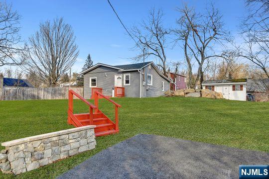 view of yard featuring fence and an outdoor structure