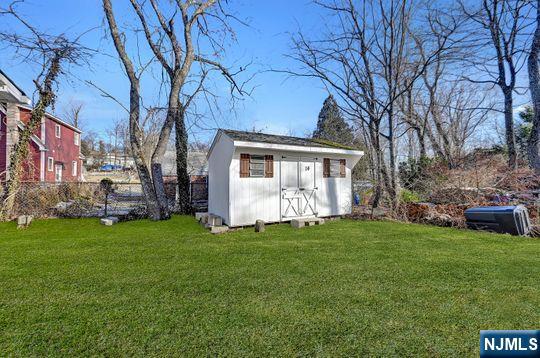 view of shed with fence