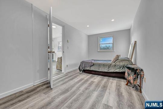 bedroom featuring recessed lighting, baseboards, and wood finished floors