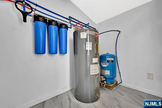 utility room featuring electric water heater