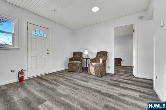 unfurnished room with wood finished floors and baseboards