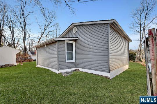 view of side of property with a yard