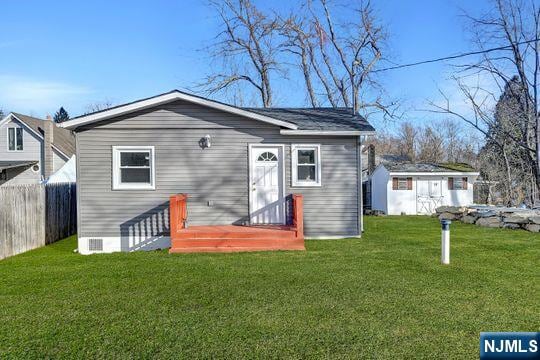 exterior space with an outbuilding and fence