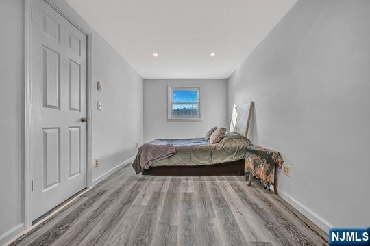 bedroom featuring baseboards and wood finished floors