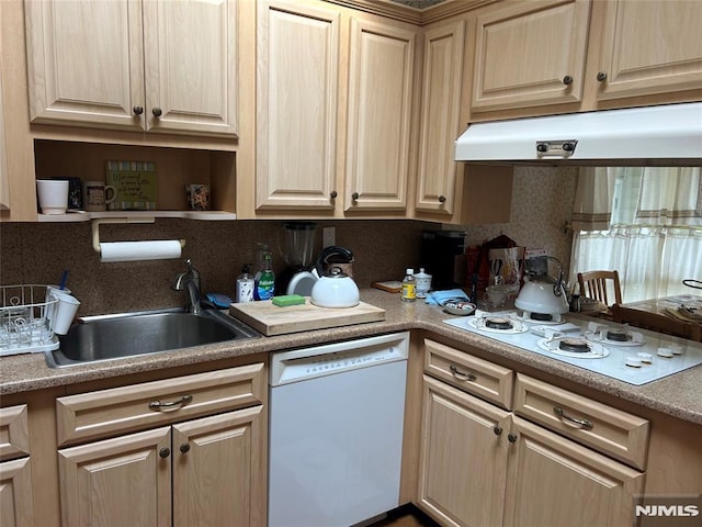 kitchen with light brown cabinetry, white appliances, a sink, and under cabinet range hood